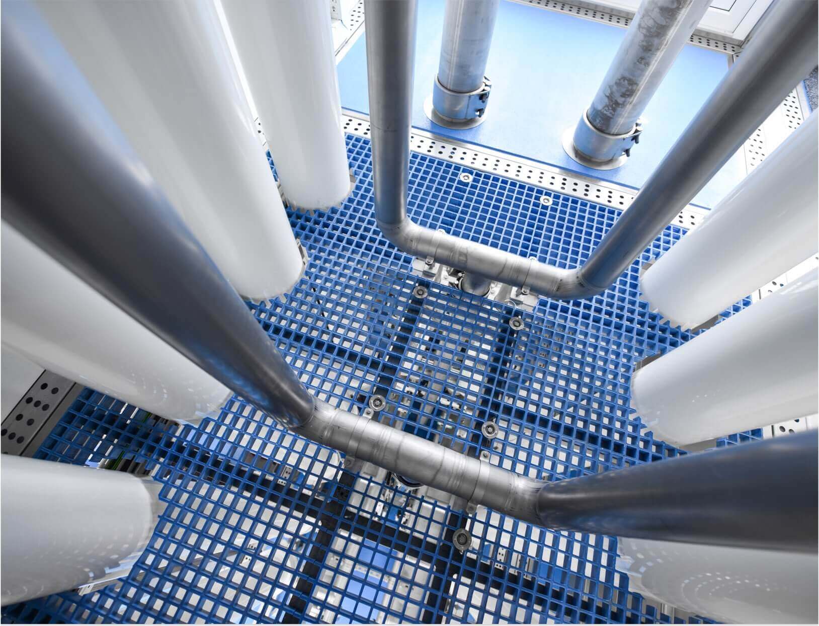 Pharmafilter installation image of white tubes and a blue steel floor